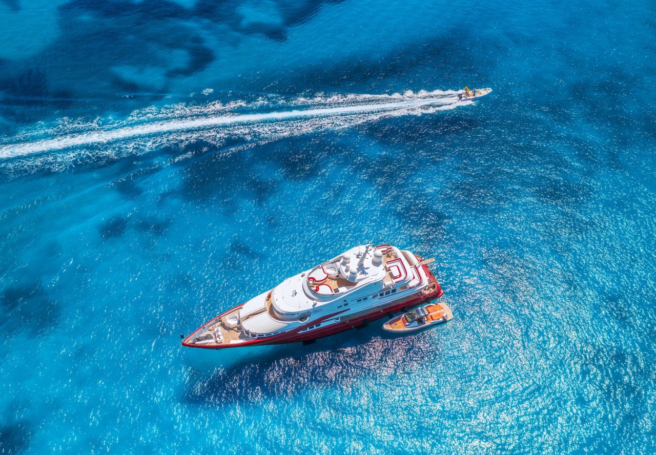 Aerial view of luxury yacht on blue water